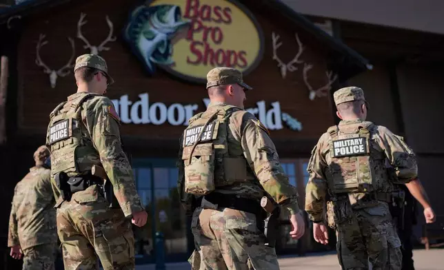 Members of National Guard patrol outside a Bass Pro Shops, Friday, Oct. 10, 2025, in Memphis, Tenn. (AP Photo/George Walker IV)