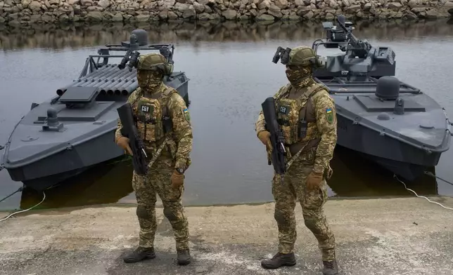 Ukraine's Security Service officers stand by Sea Baby drones, during a demonstration at an undisclosed location in Ukraine Friday, Oct. 17, 2025. (AP Photo/Efrem Lukatsky)