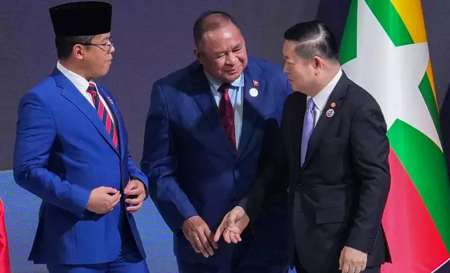 Indonesia's Foreign Minister Sugiono, left, and East Timor's Foreign Minister Bendito dos Santos Freitas, center, speak with ASEAN Secretary-General Kao Kim Hourn during the ASEAN foreign ministers/ meeting in Kuala Lumpur, Malaysia, Saturday, Oct. 25, 2025. (AP Photo/Rafiq Maqbool)