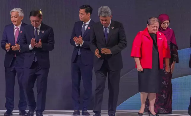 From left, Singapore's Permanent Secretary of Foreign Affairs Albert Chu, Thailand's Foreign Minister Sihasak Phuangketkeow, Vietnam's Deputy Minister of Foreign Affairs Dang Hoang Giang, Malaysia's Foreign Minister Mohamad Hasan, Philippine Foreign Secretary Theresa Lazaro and unidentified Brunei's representative leave after a group photo during ASEAN foreign ministers' meeting at the Kuala Lumpur Convention Centre in Kuala Lumpur, Malaysia, Saturday, Oct. 25, 2025. (AP Photo/Rafiq Maqbool)