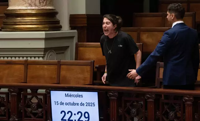 A woman shouts, "Murderers" in Spanish after Uruguay's senate passed a law decriminalizing euthanasia, in Montevideo, Uruguay, Wednesday, Oct. 15, 2025. (AP Photo/Matilde Campodonico)