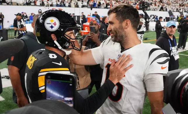 Pittsburgh Steelers quarterback Aaron Rodgers (8) and Cincinnati Bengals quarterback Joe Flacco, right, meet on the field following an NFL football game in Cincinnati, Thursday, Oct. 16, 2025. (AP Photo/Jeff Dean)