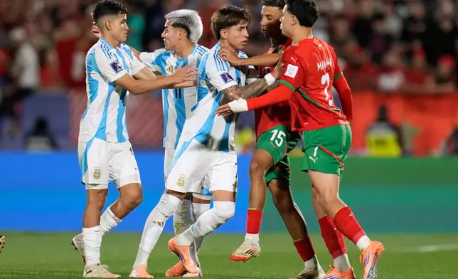 Morocco's Othmane Maamma, right, and Argentina's Maher Carrizo argue during the FIFA U-20 World Cup final soccer match in Santiago, Chile, Sunday, Oct. 19, 2025.(AP Photo/Matias Delacroix)