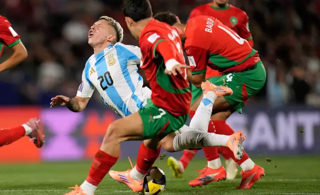 Morocco's Ismael Baouf, right, fouls Argentina's Gianluca Prestianni during the FIFA U-20 World Cup final soccer match in Santiago, Chile, Sunday, Oct. 19, 2025. (AP Photo/Matias Delacroix)