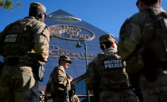 Members of National Guard patrol outside a Bass Pro Shops, Friday, Oct. 10, 2025, in Memphis, Tenn. (AP Photo/George Walker IV)