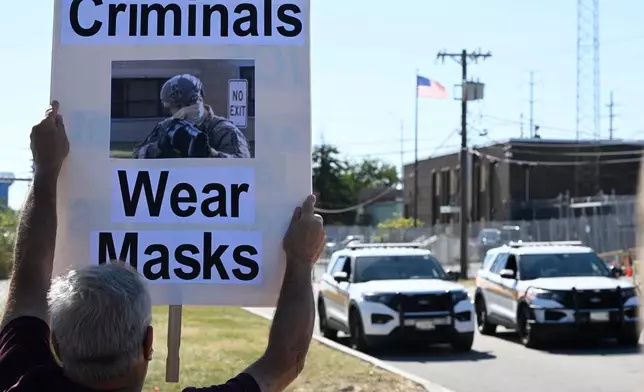 Protestors yell outside an immigration processing facility in Broadview, Ill., Thursday, Oct. 9, 2025. (AP Photo/Paul Beaty)
