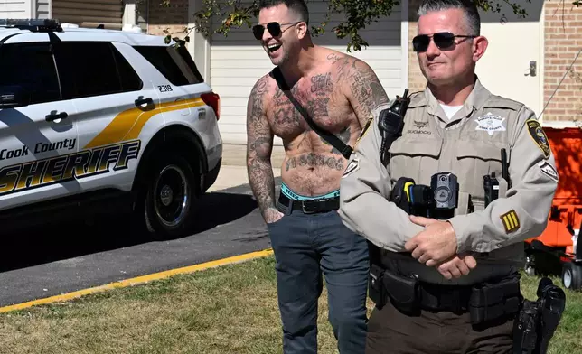 A counter protestor yells behind a Cook County Sheriff at demonstrators against ICE outside an immigration processing facility in Broadview, Ill., Thursday, Oct. 9, 2025. (AP Photo/Paul Beaty)