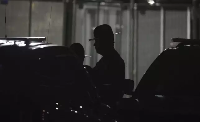An Illinois State police officer stands around after a protest curfew outside the Immigration and Customs Enforcement (ICE) processing facility in Broadview, Ill., on Thursday, Oct. 9, 2025. (AP Photo/Talia Sprague)