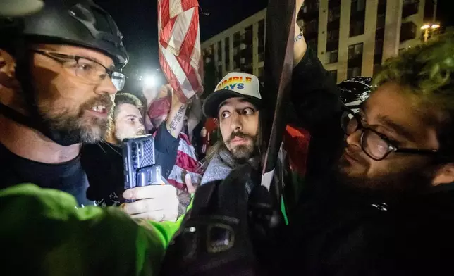 Trump supporters and protesters argue over Israeli and Palestinians outside a U.S. Immigration and Customs Enforcement facility in Portland, Ore., Monday, Oct. 6, 2025. (AP Photo/Ethan Swope)