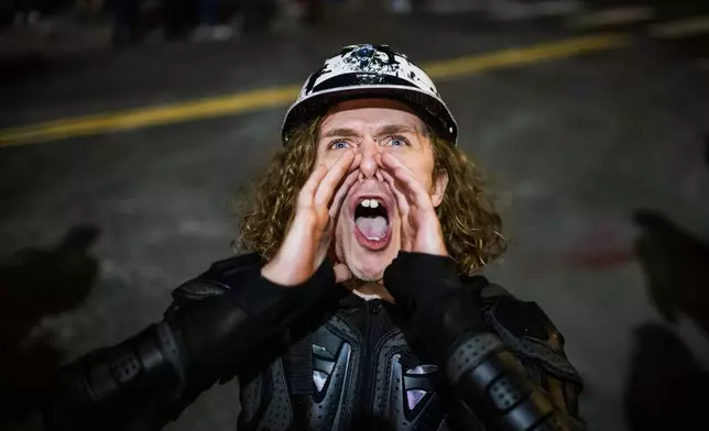 A Portland protester yells during a protest outside a U.S. Immigration and Customs Enforcement facility in Portland, Ore., Monday, Oct. 6, 2025. (AP Photo/Ethan Swope)