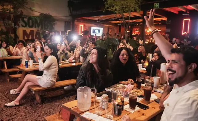 Fans gather to celebrate the release of Taylor Swift's new album, "The Life of a Showgirl" in Mexico City, Thursday, Oct. 2, 2025. (AP Photo/Claudia Rosel)