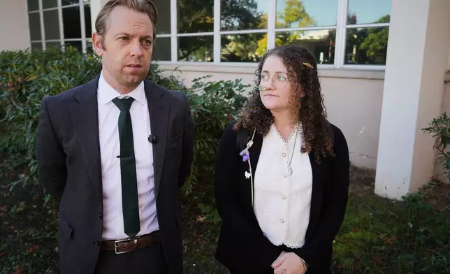 Animal rights activist Zoe Rosenberg, right, who is on trial for taking four chickens from one of Perdue Farms' major poultry plants, stands next to her attorney Chris Carraway outside Sonoma County Superior Court in Santa Rosa, Calif. on Tuesday, Oct. 28, 2025. (AP Photo/Terry Chea)