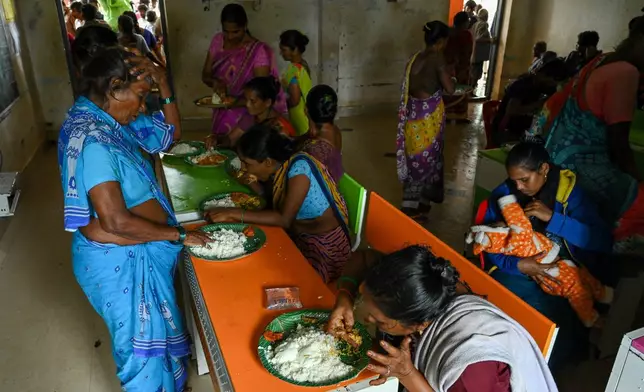 Evacuated Indian villagers of Uppada eat food in a temporary relief centre as Cyclone Montha, in Kakinada district of Andhra Pradesh, India, Tuesday, Oct. 28, 2025. (AP Photo)