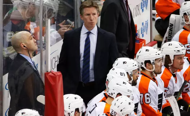 FILE - Philadelphia Flyers head coach Dave Hakstol, center, stands behind his bench during an NHL hockey game against the Pittsburgh Penguins in Pittsburgh, Thursday, Jan. 21, 2016. (AP Photo/Gene J. Puskar, File)