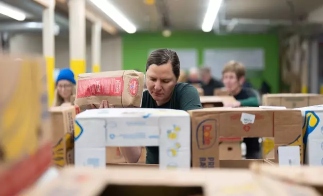 A volunteer sorts items for distribution at the Oregon Food Bank in Portland, Ore., Wednesday, Oct. 29, 2025. (AP Photo/Jenny Kane)