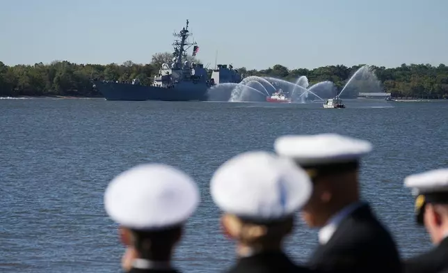 Spectators look on as U.S. Navy ships pass the viewing stand during the 250th anniversary of the founding of the U.S. Navy and Marine Corps, along the Delaware River, Thursday, Oct. 9, 2025, in Philadelphia. (AP Photo/Matt Rourke)