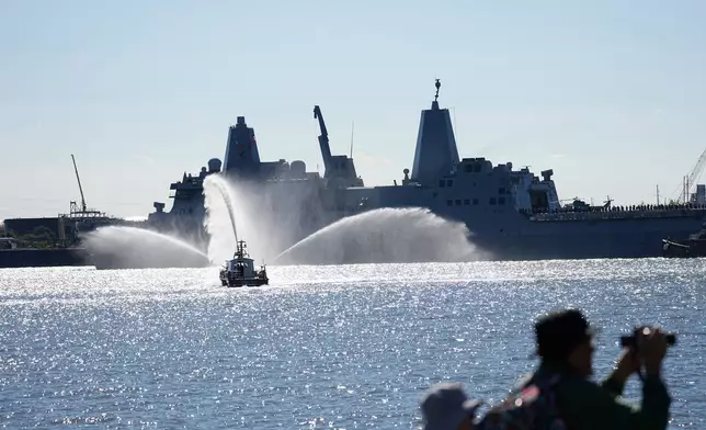 USS Arlington passes the viewing stand during the 250th anniversary of the founding of the U.S. Navy and Marine Corps, along the Delaware River, Thursday, Oct. 9, 2025, in Philadelphia. (AP Photo/Matt Rourke)