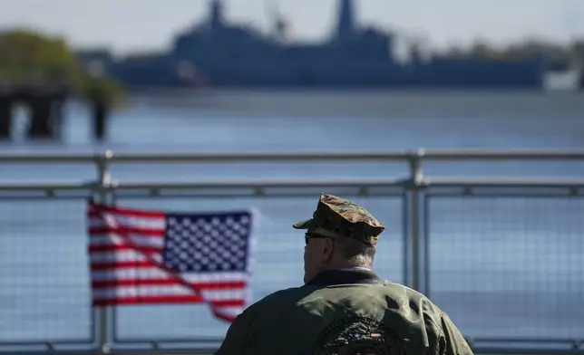 John Robertson, Navy and Marine Corps veteran, watch the U.S. Navy ships pass the viewing stand during the 250th anniversary of the founding of the U.S. Navy and Marine Corps, along the Delaware River, Thursday, Oct. 9, 2025, in Philadelphia. (AP Photo/Matt Rourke)