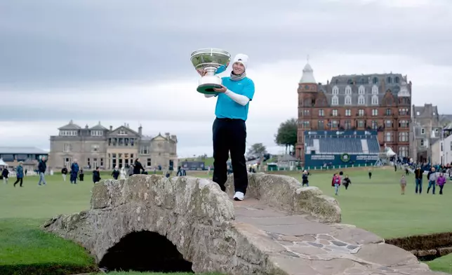 Scotland's Robert McIntyre poses with the trophy after winning the 2025 Alfred Dunhill Links Championship at the Old Course, St Andrews, Scotland, Sunday, Oct. 5, 2025. (Jane Barlow/PA via AP)