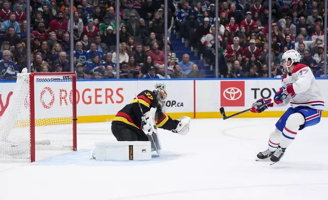 Montreal Canadiens' Josh Anderson (17) hits the post behind Vancouver Canucks goalie Kevin Lankinen (32) on a breakaway during the second period of an NHL hockey game in Vancouver, on Saturday, Oct. 25, 2025. (Darryl Dyck/The Canadian Press via AP)