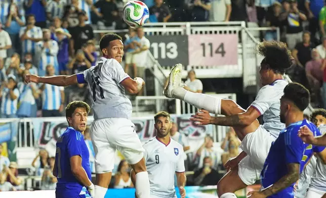 Puerto Rico's Isaac Angking (8) kicks the ball during the first half of a friendly soccer match against Argentina, Tuesday, Oct. 14, 2025, in Fort Lauderdale, Fla. (AP Photo/Marta Lavandier)