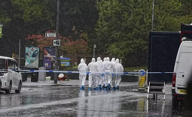 Police officers attend the scene of attack at Heaton Park Hebrew Congregation synagogue in Crumpsall, Manchester, England, Saturday Oct. 4, 2025. (Peter Byrne/PA via AP)