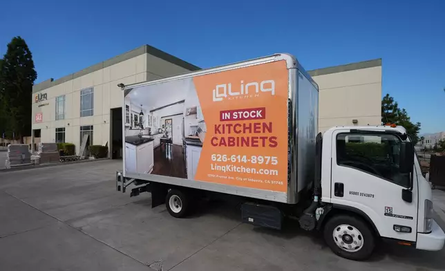 A truck stands outside a show room and warehouse belonging to Linq Kitchen, a designer and maker of kitchen cabinets in City of Industry, Calif., Friday, Oct. 10, 2025. (AP Photo/Damian Dovarganes)
