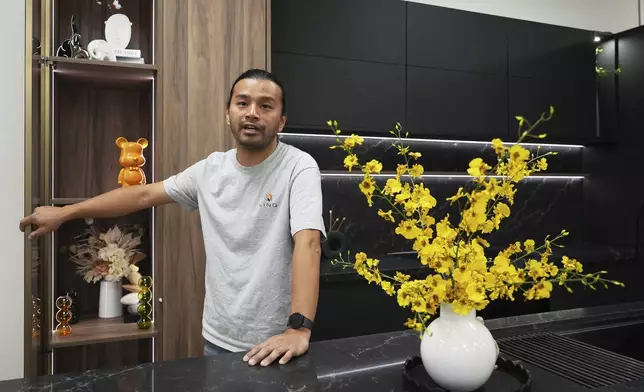 Josh Qian, co-founder of Linq Kitchen, a designer and maker of kitchen cabinets, shows his company's show room and warehouse in City of Industry, Calif., Friday, Oct. 10, 2025. (AP Photo/Damian Dovarganes)