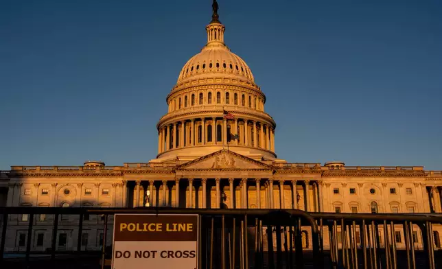The Capitol is illuminated at dawn in Washington, Monday, Oct. 6, 2025. (AP Photo/J. Scott Applewhite)