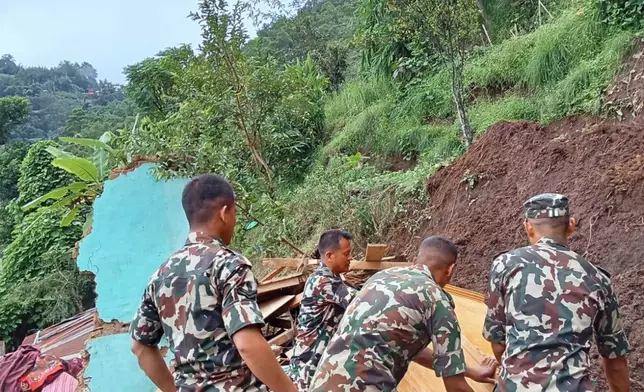 Nepalese army personnel search for survivors after landslides swept through Nepal's eastern mountain district of Illam, Nepal, Sunday, Oct. 5, 2025. (Nepal Army via AP)