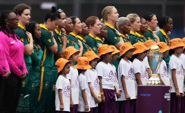 South Africa's players stands for national anthem during the ICC Women's Cricket World Cup match between Australia and South Africa in Indore, India, Saturday, Oct. 25, 2025. (AP Photo/Ajit Solanki)