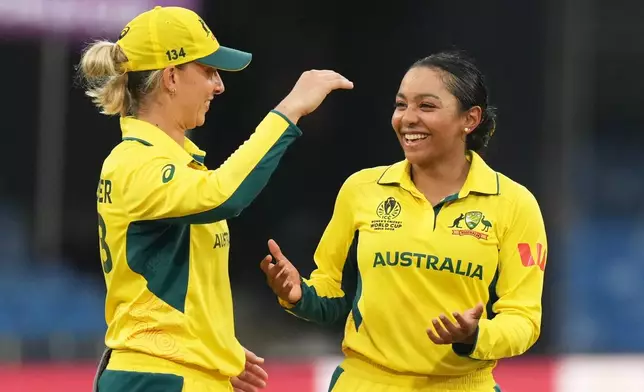 Australia's Alana King, right, celebrates the wicket of South Africa's Nadine de Klerk during the ICC Women's Cricket World Cup match between Australia and South Africa in Indore, India, Saturday, Oct. 25, 2025. (AP Photo/Ajit Solanki)