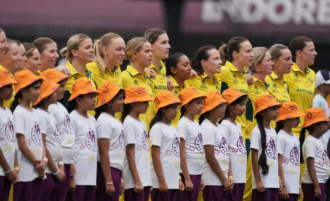Australia's players stands for national anthem during the ICC Women's Cricket World Cup match between Australia and South Africa in Indore, India, Saturday, Oct. 25, 2025. (AP Photo/Ajit Solanki)