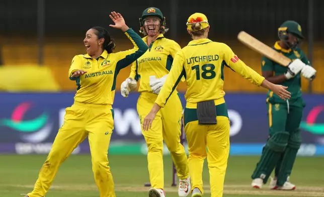 Australia's Alana King, left, celebrates with teammate the wicket of South Africa's Sinola Jafta during the ICC Women's Cricket World Cup match between Australia and South Africa in Indore, India, Saturday, Oct. 25, 2025. (AP Photo/Ajit Solanki)