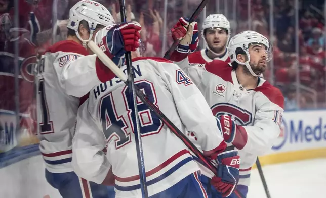 Montreal Canadiens' Alex Newhook (right) celebrates is goal against the Edmonton Oilers with teammates during first period NHL action, in Edmonton on Thursday, Oct. 23, 2025. (Jason Franson/The Canadian Press via AP)