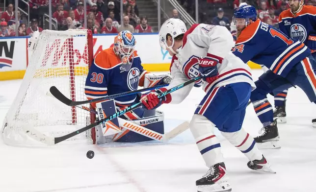 Montreal Canadiens' Cole Caufield (13) is stopped by Edmonton Oilers goalie Calvin Pickard (30) during first period NHL action, in Edmonton on Thursday, Oct. 23, 2025. (Jason Franson/The Canadian Press via AP)