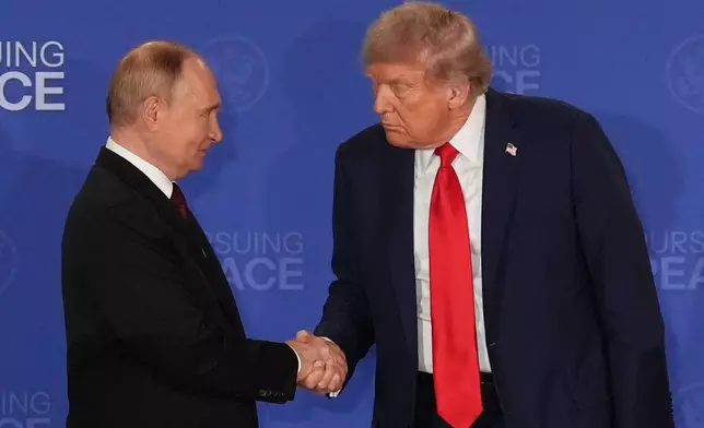 FILE - President Donald Trump, right, shakes the hand of Russia's President Vladimir Putin during a joint press conference at Joint Base Elmendorf-Richardson, Alaska, Aug. 15, 2025. (AP Photo/Jae C. Hong, File)