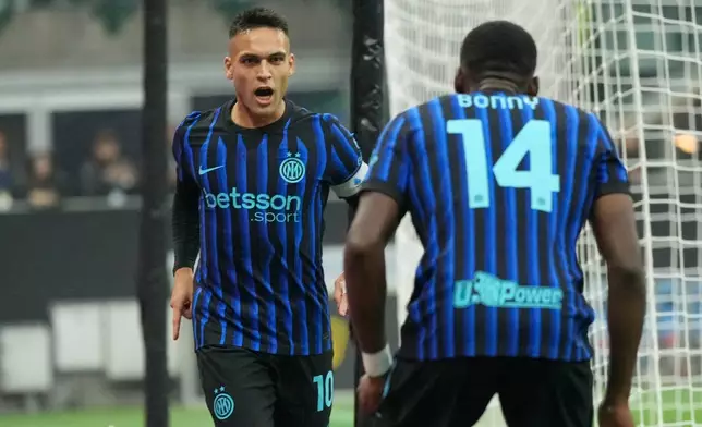 Inter Milan's Lautaro Martinez, left, celebrates with Inter Milan's Ange-Yoan Bonny after scoring his side's opening goal during the Serie A soccer match between Inter Milan and Cremonese at the San Siro stadium in Milan, Italy, Saturday, Oct. 4, 2025. (AP Photo/Luca Bruno)