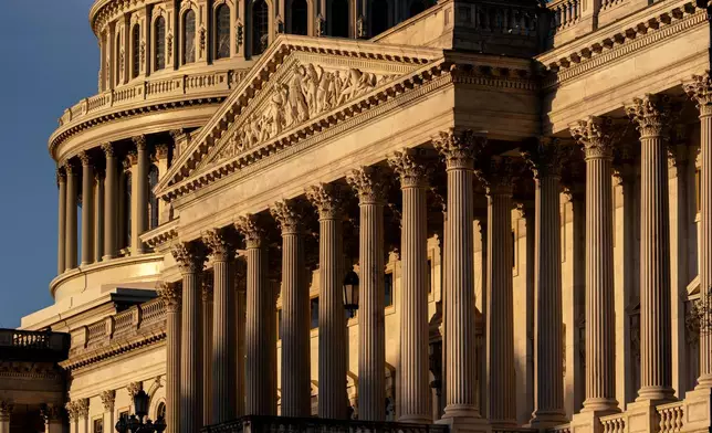 The Capitol is illuminated at sunrise to begin day three of a government shutdown, in Washington, Friday, Oct. 3, 2025. (AP Photo/J. Scott Applewhite)