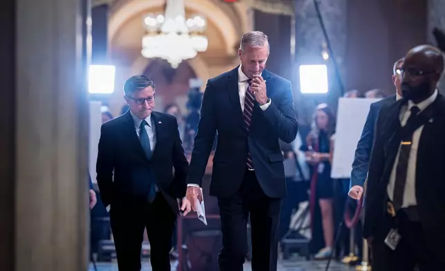 Speaker of the House Mike Johnson, R-La., left, and Senate Majority Leader John Thune, R-S.D., return to their offices after meeting with reporters on the third day of the government shutdown, at the Capitol in Washington, Friday, Oct. 3, 2025. (AP Photo/J. Scott Applewhite)