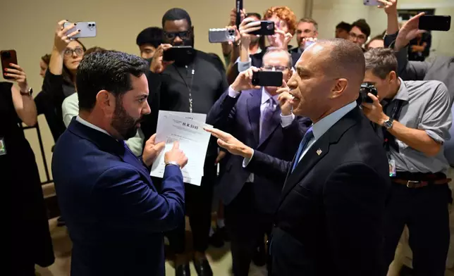 Rep. Michael Lawler, R-N.Y., left, confronts House Minority Leader Hakeem Jeffries, D-N.Y., in a heated discussion to endorse House bill H.R.5145 that would extend the American Rescue Plan Act of 2021 (ARPA) and the Inflation Reduction Act of 2022 at the U.S. Capitol on Wednesday, Oct. 8, 2025, in Washington. (AP Photo/John McDonnell)