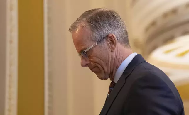 Senate Majority Leader John Thune, R-S.D., speaks to member of the media before voting at the Capitol on the ninth day of the government shutdown in Washington, Thursday, Oct. 9, 2025. (AP Photo/Allison Robbert)