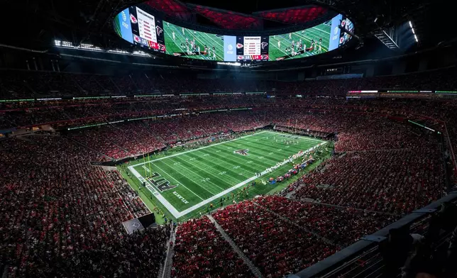 FILE - Fans watch action at the Mercedes-Benz Stadium during an NFL football game between the Atlanta Falcons and the Kansas City Chiefs, Sept. 22, 2024, in Atlanta. (AP Photo/Danny Karnik, File)