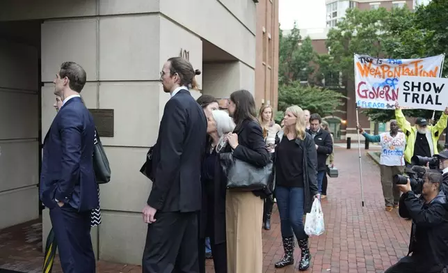 Family of former FBI Director James Comey and others, arrive at federal court in Alexandria, Va., Wednesday, Oct. 8, 2025. (AP Photo/Alex Brandon)