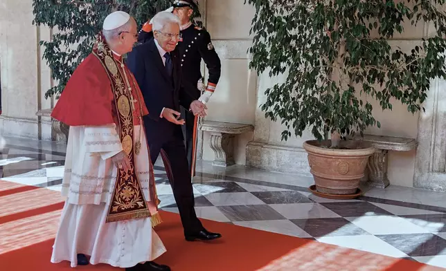 Italian President Sergio Mattarella, right, welcomes Pope Leo XIV as he arrives at the Quirinale Presidential Palace in Rome, Tuesday, Oct. 14, 2025. (Roberto Monaldo/LaPresse via AP)
