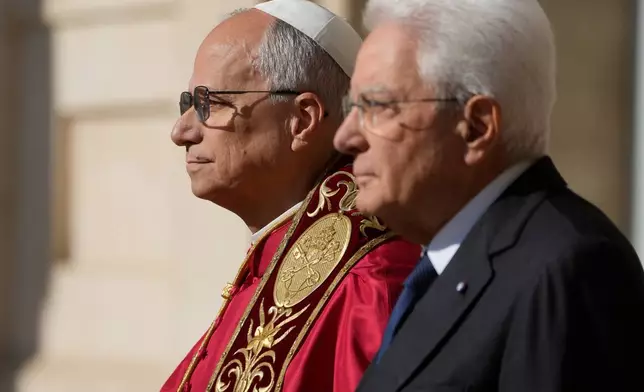 Pope Leo XIV is welcomed by Italian President Sergio Mattarella, right, as he arrives at the Quirinale Presidential Palace in Rome, Tuesday, Oct. 14, 2025. (AP Photo/Gregorio Borgia)