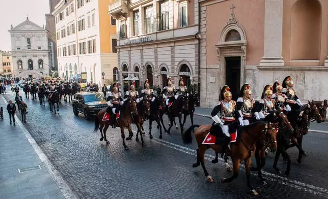 Mounted cuirassiers escort Pope Leo XIV as he arrives in a car at the Quirinale Presidential Palace in Rome, Tuesday, Oct. 14, 2025. (Valentina Stefanelli/LaPresse via AP)