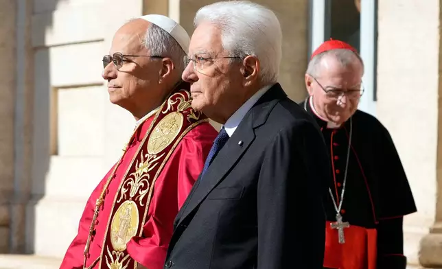 Pope Leo XIV, left, is welcomed by Italian President Sergio Mattarella as he arrives at the Quirinale Presidential Palace in Rome, Tuesday, Oct. 14, 2025. At right Vatican Secretary of State Cardinal Pietro Parolin. (AP Photo/Gregorio Borgia)