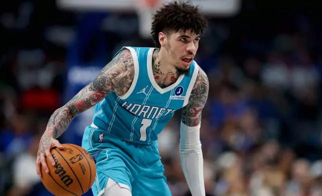 Charlotte Hornets guard Lamelo Ball looks to the basket during the second half of an NBA basketball preseason game against the Dallas Mavericks in Dallas, Saturday, Oct. 11, 2025. (AP Photo/Gareth Patterson)