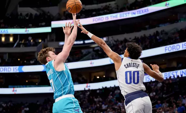 Charlotte Hornets guard Kon Knueppel (7) shoots over Dallas Mavericks guard Max Christie (00) during the second half of an NBA basketball preseason game in Dallas, Saturday, Oct. 11, 2025. (AP Photo/Gareth Patterson)